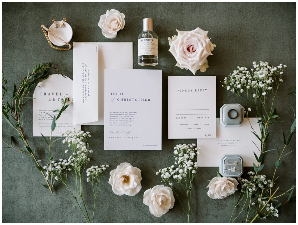 wedding flat lay with baby's breath on a dark surface