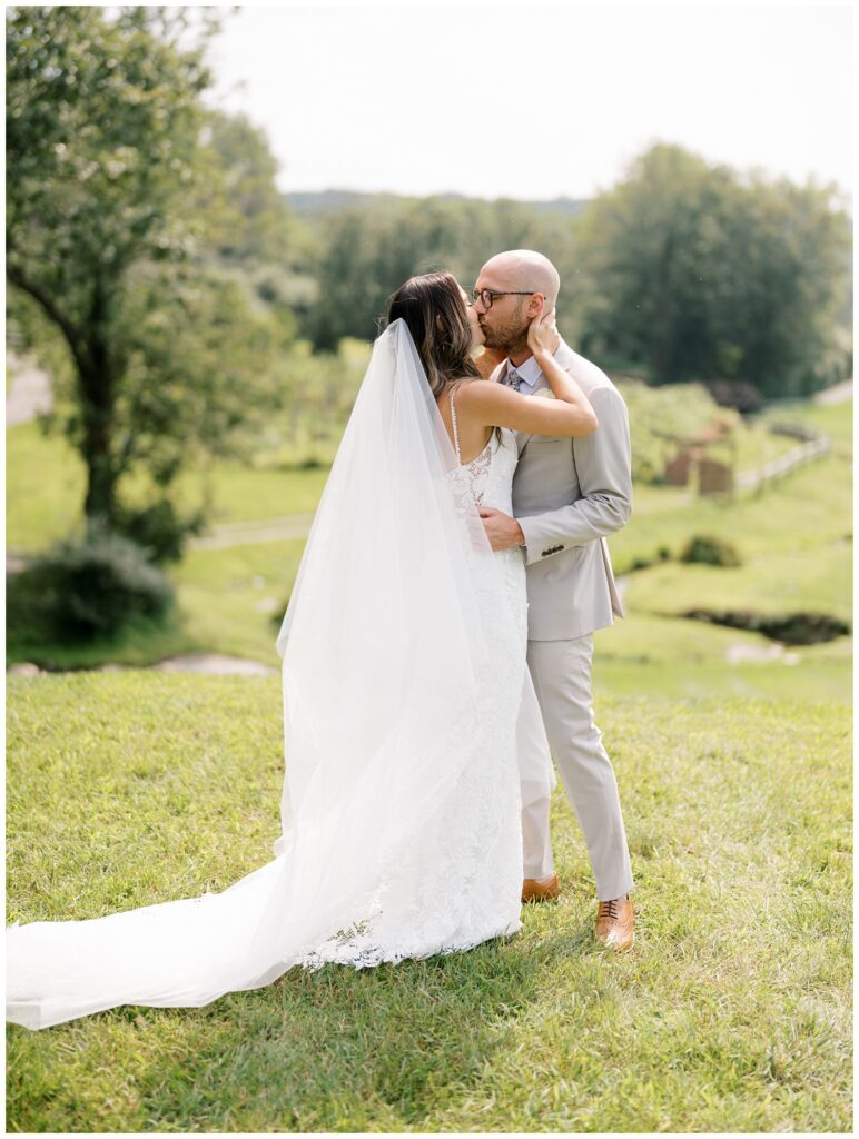 bride and groom kissing on the outside grounds at Bear Brook Valley