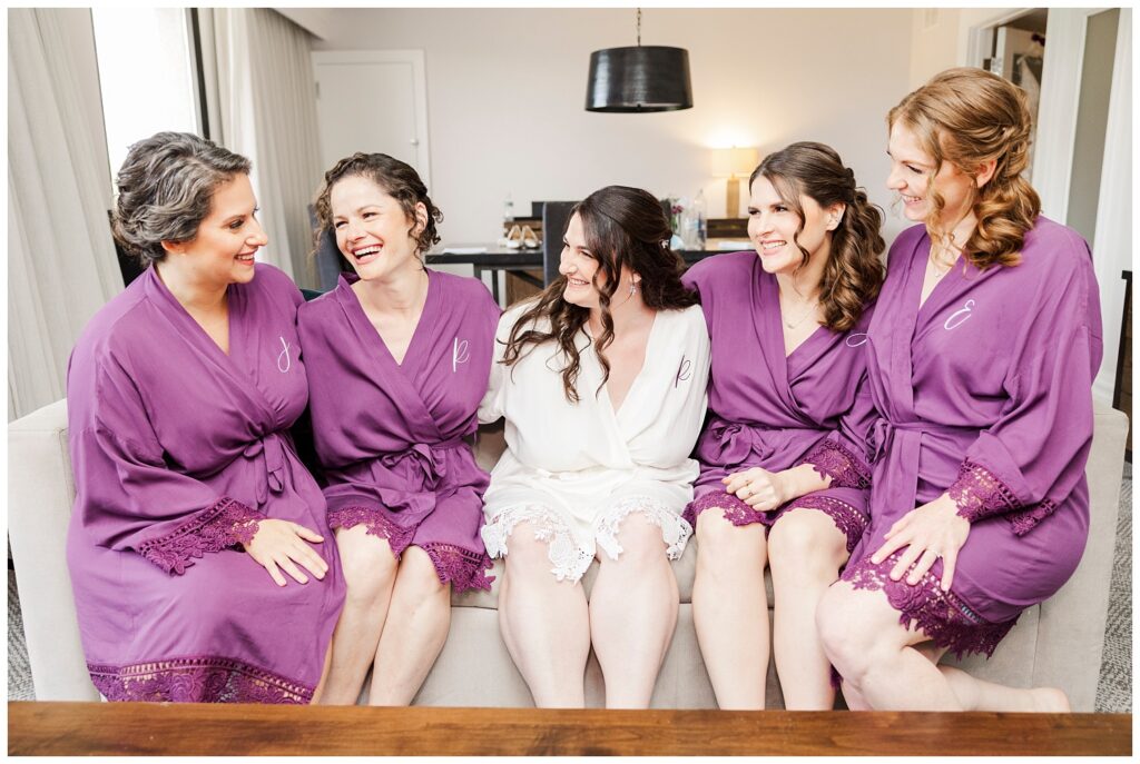 bride sitting on a couch with bridesmaids at Briarcliff Manor