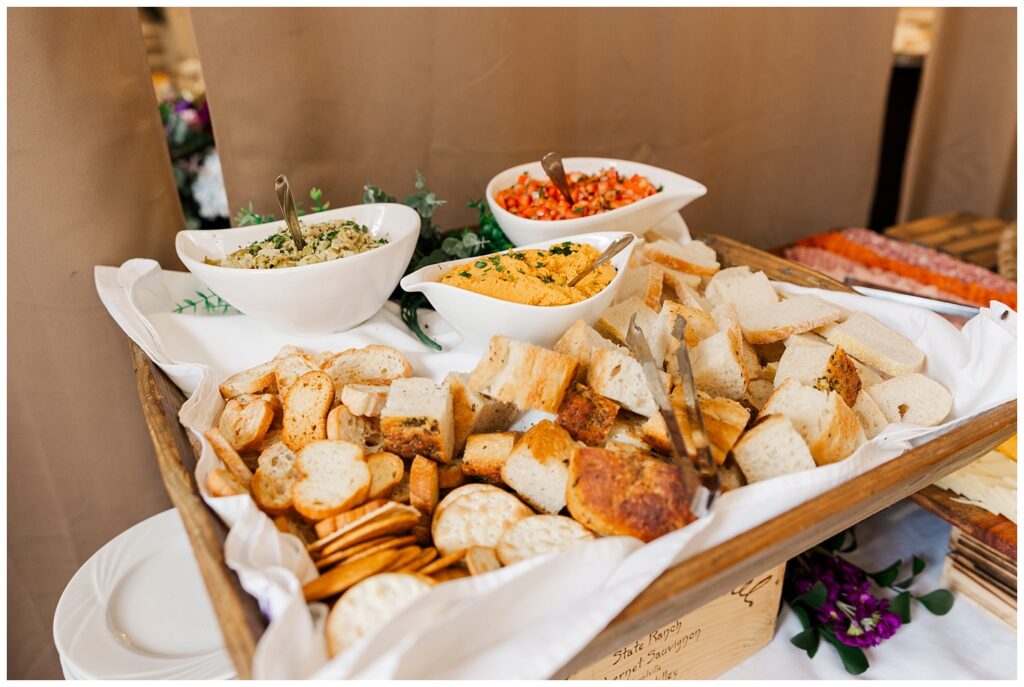 crusty bread and dips sitting on a food table at Briarcliff Manor reception