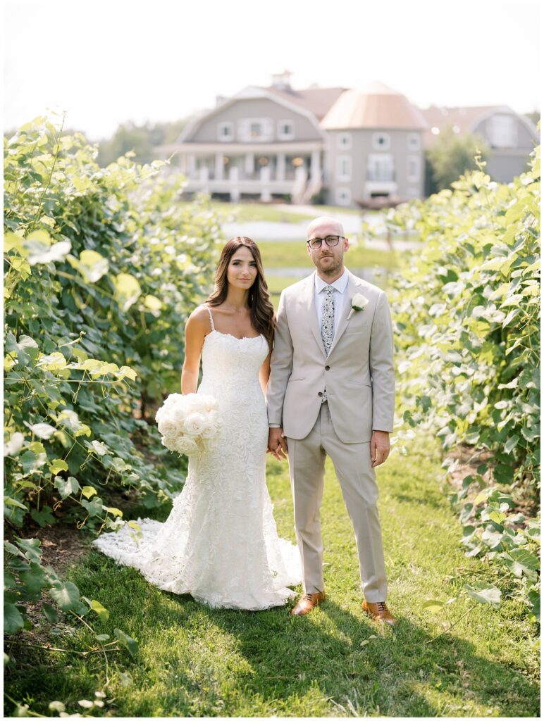 bride and groom posing together in the vineyard at Bear Brook Valley