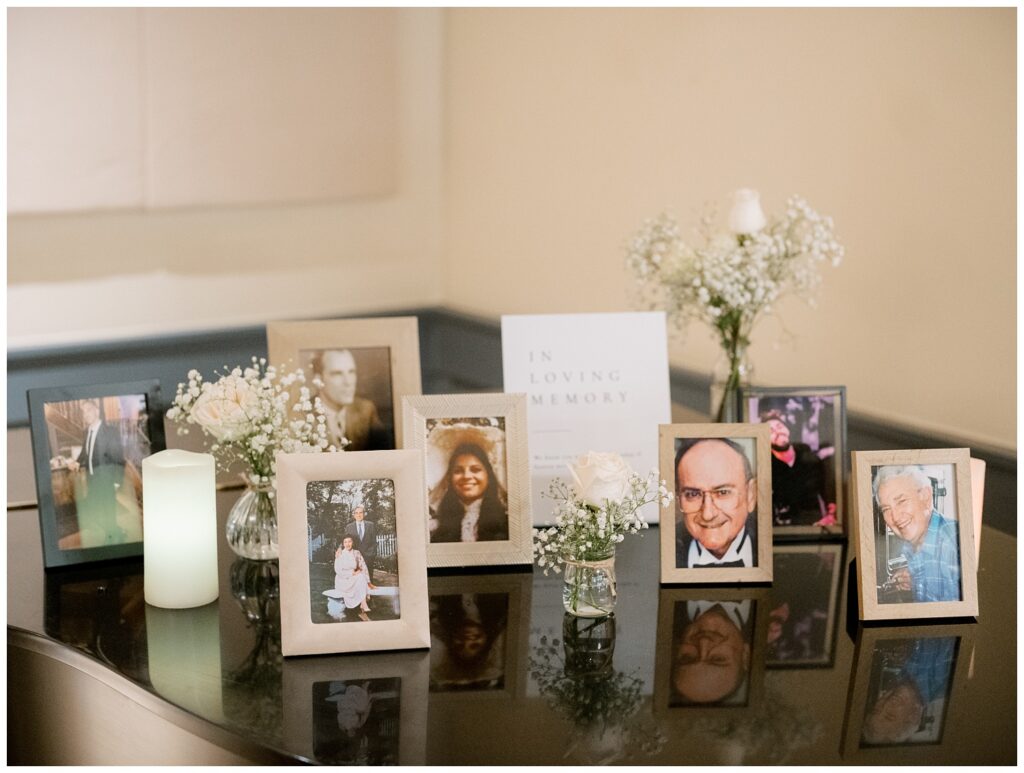 framed photos of loved ones sitting on a black piano at New Jersey wedding venue