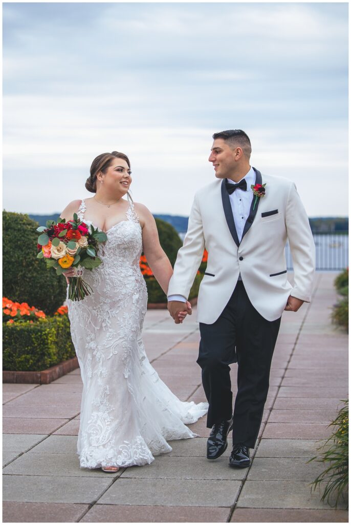 bride and groom walking hand in hand at The Molly Pitcher Inn at Asbury Park