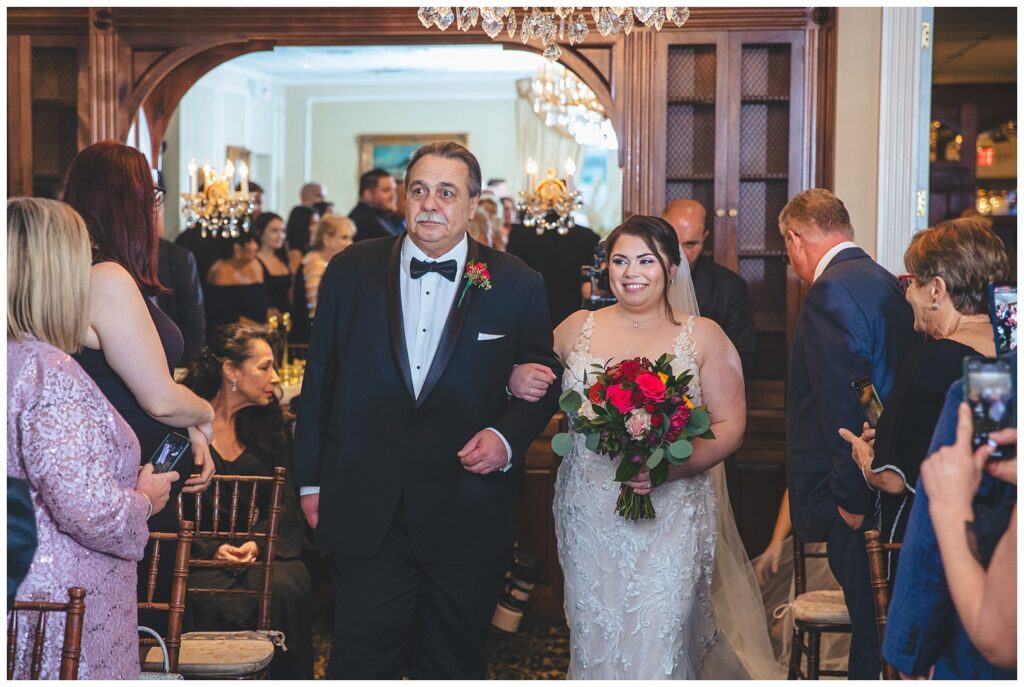 bride walking down the aisle at indoor wedding at The Molly Pitcher Inn