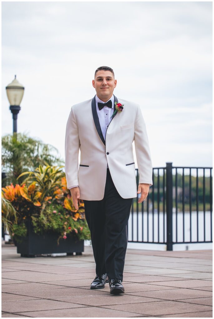 groom walking across the outside grounds at The Molly Pitcher Inn