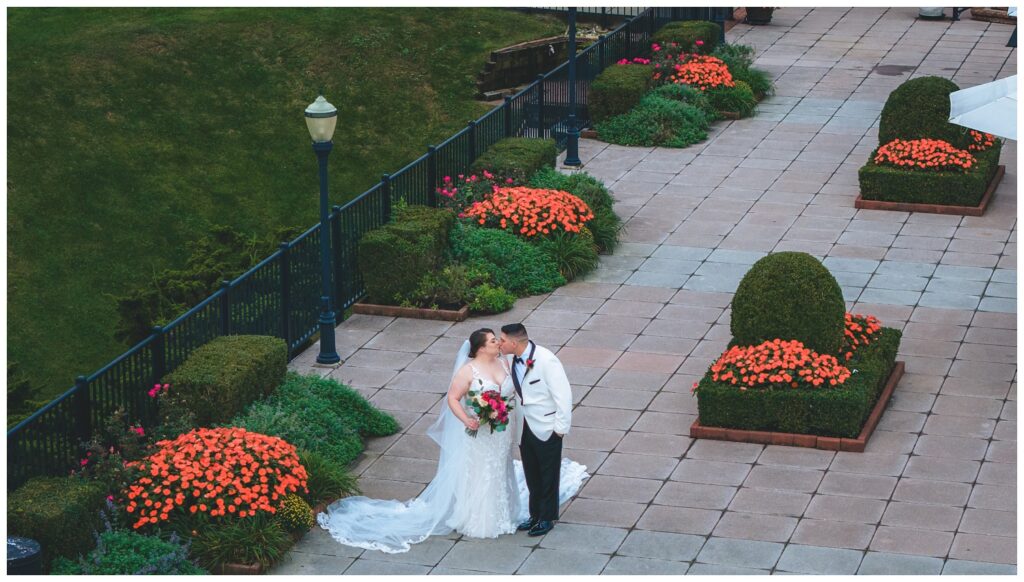 bride and groom share a kiss on the outdoor platform at The Molly Pitcher Inn