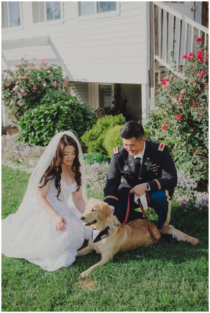 wedding couple posing with their dog before the ceremony