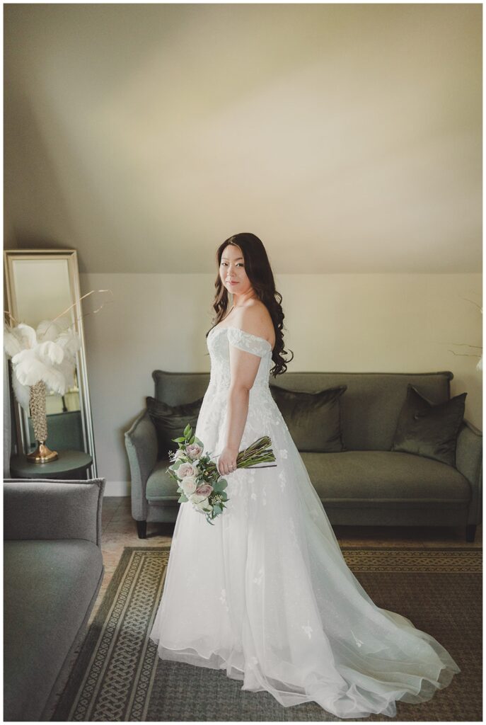 bride posing in her gown while holding a bouquet at Staten Island wedding venue