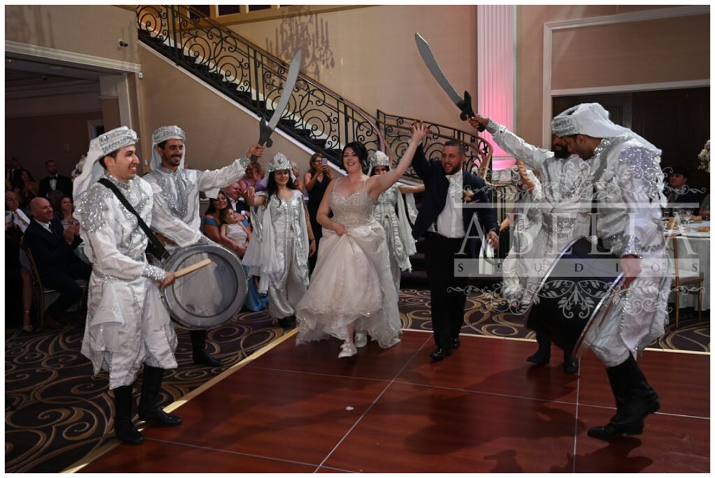 Dabke dancing group welcoming the bride and groom into the wedding reception 