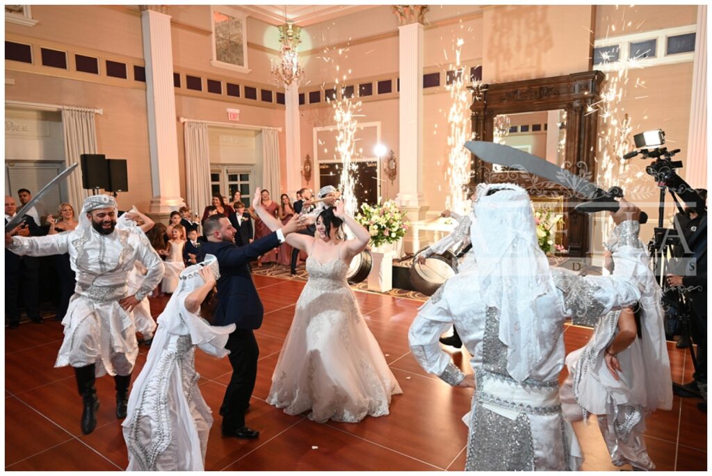 Dabke dancing group circling the bride and groom at the wedding reception in New Jersey