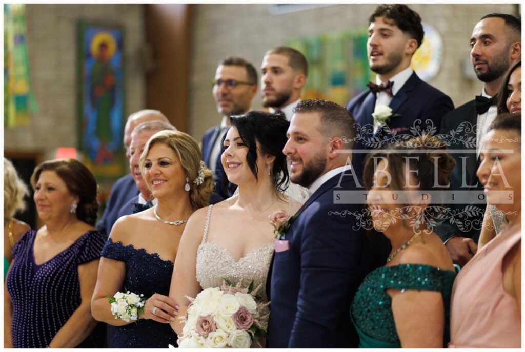 wedding couple posing with entire party at St. Matthias Catholic Church in Somerset, New Jersey