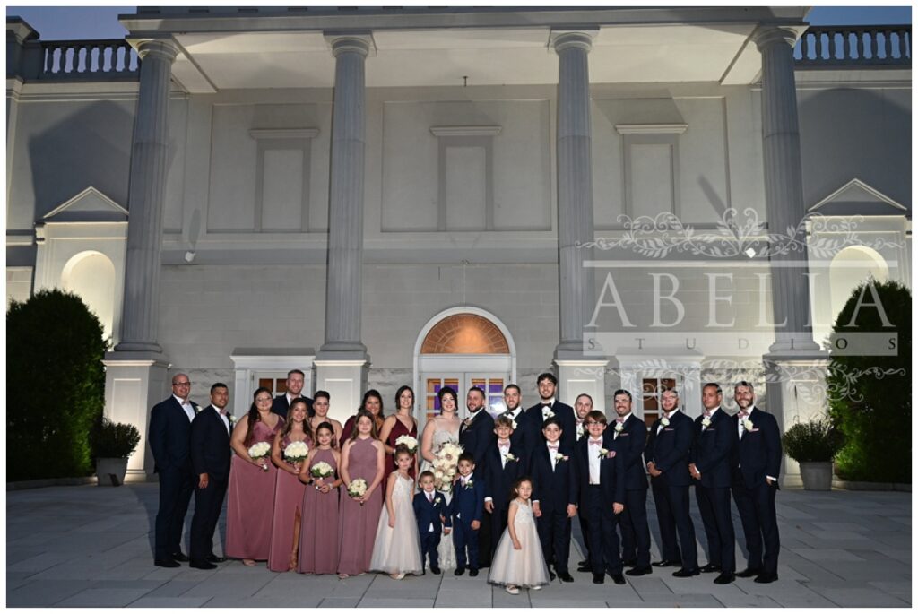 full bridal party portraits outside the front entrance of the Palace at Somerset Park venue