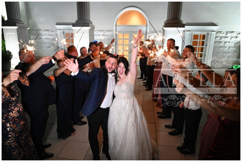 bride and groom cheer during sparkler reception exit from the Palace at Somerset Park wedding venue