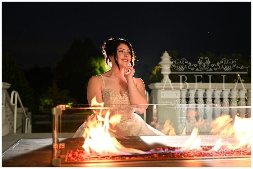 bride sitting in front of a fire table outside at night in Somerset, New Jersey