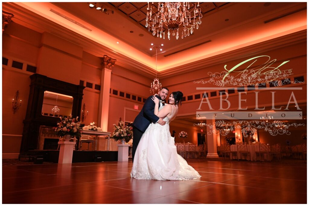 bride and groom have first dance at reception before guests come in 
